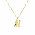 Close-up of golden balloon letter N pendant with high-shine polished fluid metal surface - Necklace N