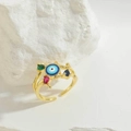 Detail von Vintage-Ring mit blauem Auge und bunten Edelsteinen auf Gold-Ringband - Grüner Zirkonia