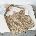 Detailed macro view of yellow canvas tote bag with white daisy floral pattern and EMIS tag - Yellow Flower Camel