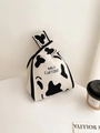 Knitted cow print bucket bag with milk cartons pattern and unique knotted handle design - Cow Pattern with Black Edge