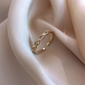 Minimalist gold braided twist open ring with zircon accents on soft beige silk background - Twist Sparkling Zirconia