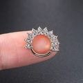 Macro shot of silver hinged septum ring with sunburst zircon crown held between fingers - Silver Sunburst Hoop