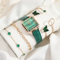 Close-up of green emerald watch set with butterfly bracelet on white silk display - Green Watch Set 2 (orange Box)
