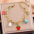 Gold stainless steel bracelet with strawberry, flower, butterfly and pearl charms - Bracelet