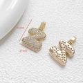 Macro detail of gold letter Z pendant with cubic zirconia and hollow floral back - Letter Z