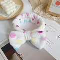 Soft white plush headband featuring colorful polka dots and a large decorative bow - White Polka Dot