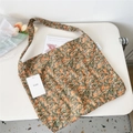 Detailed close-up of a floral canvas tote bag featuring orange flowers and a MISS brand tag - 26 Green Base Mandala Flower