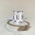 Macro shot of 4-carat emerald cut moissanite ring with detailed stone facets - US 5 / Emerald Cut 4ct Pave-Silver