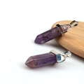 Hexagonal amethyst crystal column pendant with silver metal clasp on white background - Purple Crystal