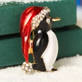 Sparkling penguin Christmas brooch with colorful enamel and rhinestones on snow - Penguin with Hat