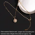 Golden rotating star and flower pendant necklace in titanium steel with sparkling zircons - Starburst Flower Style (A692)