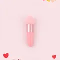 Macro shot of heart-shaped makeup sponge brush with pink handle and rose gold metal ferrule - Single Pack / Rose Gold Tube + Pink Teardrop Head