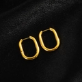Detailed view of polished gold oval hoop earrings with a secure clasp on black velvet - Oval Smooth / Gold