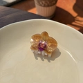 Detail of amber acrylic orchid hair claw clip with semi-transparent petals in a ceramic dish - Brown Flower - Small Claw