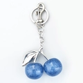 Portachiavi a ciliegia in resina blu glitterata con foglie in metallo argento - Bianco K Blu