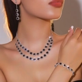 Silver bridal jewelry set with dark blue gems and double layer necklace on model - Necklace + Earrings + Bracelet / Dark Gem 3-Piece Set(DTN14026404-3BK)