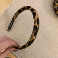 Detail of leopard print headband featuring a woven texture and a 'HAND MADE' woven label - Headband / 1.5cm Width / Dark Leopard Print