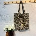 Faux fur leopard print tote bag with plush texture and handmade metal badge detail - Coffee Leopard