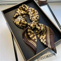 Elegant coffee brown silk scarf with golden H-pattern displayed on metal tray - Gold