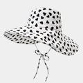 White wide brim sun hat with black heart print and decorative bow tie strap - One Size / White