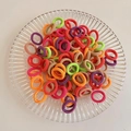 Elastic cartoon hair bands set in vibrant colors displayed on a textured glass tray - Colorful Stripes 100Pcs OPP Bag