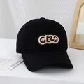 Close-up of a black baseball cap featuring brown GELD embroidery with white border detail - Black / 54cm (3-8 Years)
