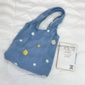 Detail of blue faux shearling tote bag with embroidered star and planet patterns - Plush Blue Space Pattern Bag