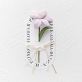 Detailed view of a hand-knitted purple lily with a decorative Love Is Eternal ribbon - Blooming Tulip - Light Purple