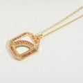 Macro view of gold rectangle necklace pendant with rainbow gemstones and pink zircon edges - Rectangle Rainbow (White)