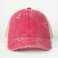 Detailed close-up of distressed ponytail trucker hat with mesh back and vintage pink fabric - One Size / Watermelon red
