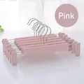 Detail of adjustable clips on dusty pink non-slip pants hangers for home organization - Nordic Pink