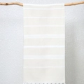 Turkish fringed beach towel in beige with white stripes hanging on a branch - Beige