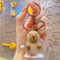 Wind-up Capybara keychain plush toy in beige and brown being held by hand - Wind-up Capybara - Khaki White