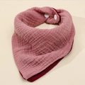 Detail of pink cotton muslin baby bib with soft wrinkled texture and white snap button - Deep Pink + Wine Red