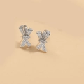 Detail of silver bow earrings with micro-paved clear cubic zirconia on beige background - ES2560 Short Bow