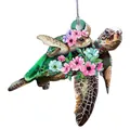 Detailed view of turtle pendant with floral patterns and woven cord attachment - C-Floral Turtle Family
