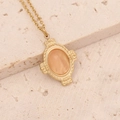 Close-up of golden necklace with an oval orange natural stone in an ornate frame - Orange Gemstone Style (3#)