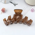 Brown translucent wave-shaped matte hair claw clip for elegant bun hairstyles - Brown