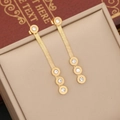 Golden herringbone chain earrings with round zircon charms and Roman numerals in a box - Earrings