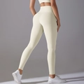 Detail view of high-waisted cream yoga leggings showing slimming fit and butt-lifting seam - S / Light Ivory