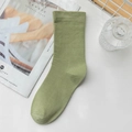 Minimalist light green cotton mid-calf socks with ribbed cuffs on white surface - Dark Green