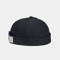 Detail of vintage denim docker hat featuring a textile logo patch and reinforced stitching - Black