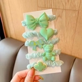 Detail of 5-piece mint green hair scrunchies set featuring cute resin bear and bow charms - Green Series 5-Piece Set
