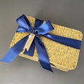 Macro view of woven seagrass gift box with dark blue ribbon bow and thank you tag - Navy Blue (DIY Ribbon)