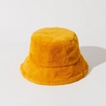 Macro shot of the soft yellow faux rabbit fur texture on a warm bucket hat - Ginger Yellow