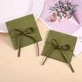 Detail of olive green microfiber jewelry pouch featuring a soft texture and silk ribbon bow - 8*8cm / Green