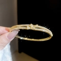 Close-up of 18k gold plated double-row zircon bracelet with center bow knot design - Gold (Double Layer Bow)
