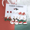 Christmas earring set with snowman, reindeer, and wreath studs on festive background - Model 11 A-1402