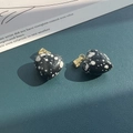 Detailed macro shot of heart-shaped natural stone pendants with gold metal clasps - Snowflake Obsidian