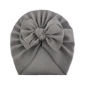 Detail of soft dark grey waffle knit baby turban hat with a large decorative bow tie - Gray
